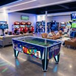 Micro-Football Table arcade machine displayed in a modern game center, commercial coin-operated football table for entertainment venues