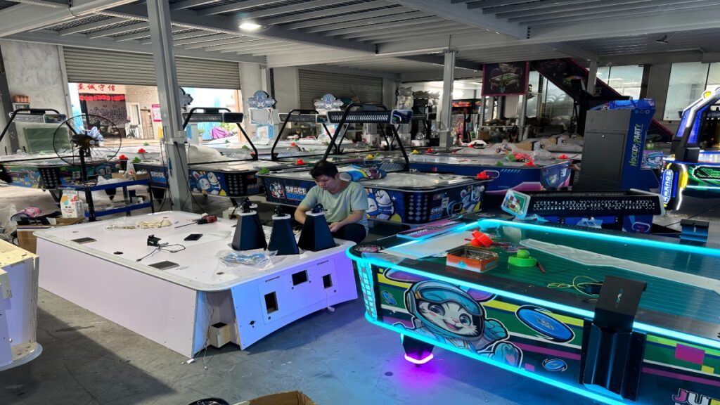 Amusement machine factory production area with commercial arcade machines being assembled and inspected