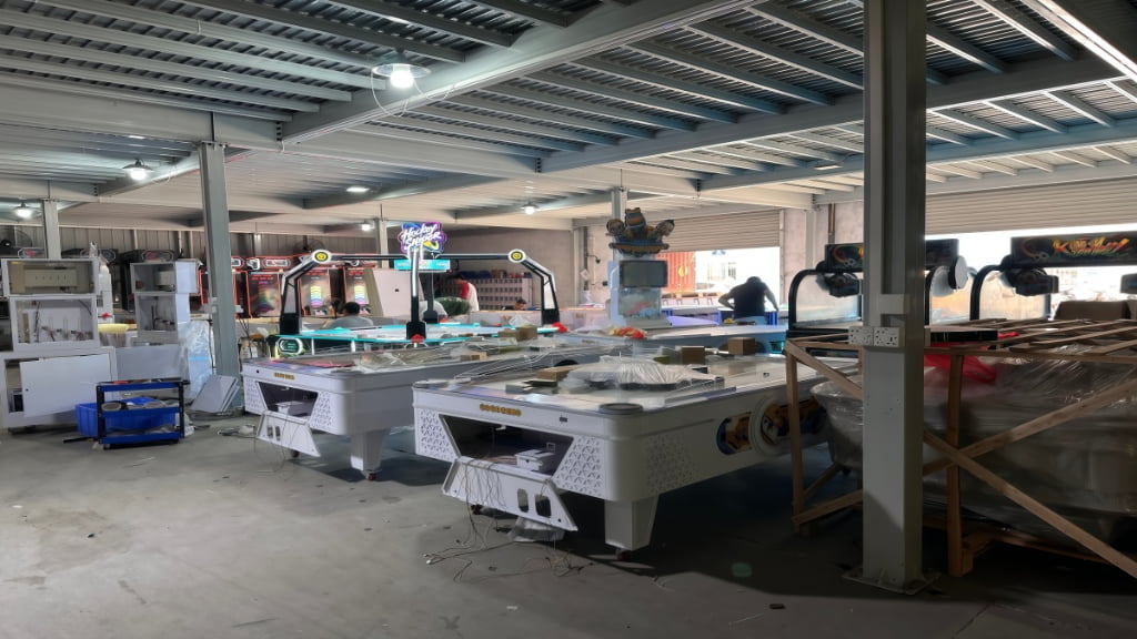 Fish game machine factory production process with arcade cabinets being assembled