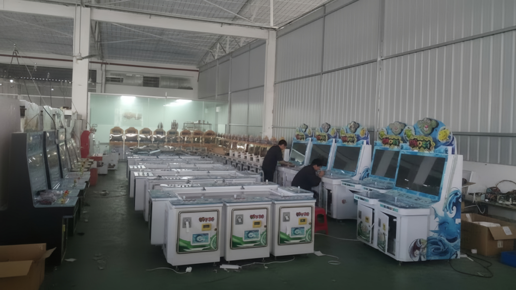 Fish game machine factory workshop with arcade cabinets being assembled and tested by technicians