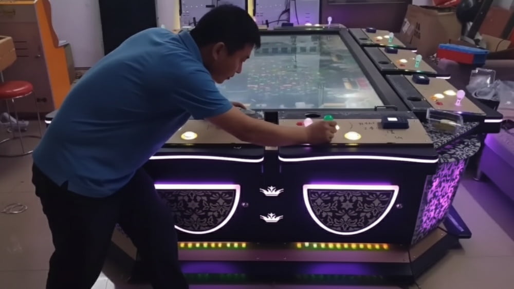 Technician checking screen position and control panel layout on a custom arcade cabinet