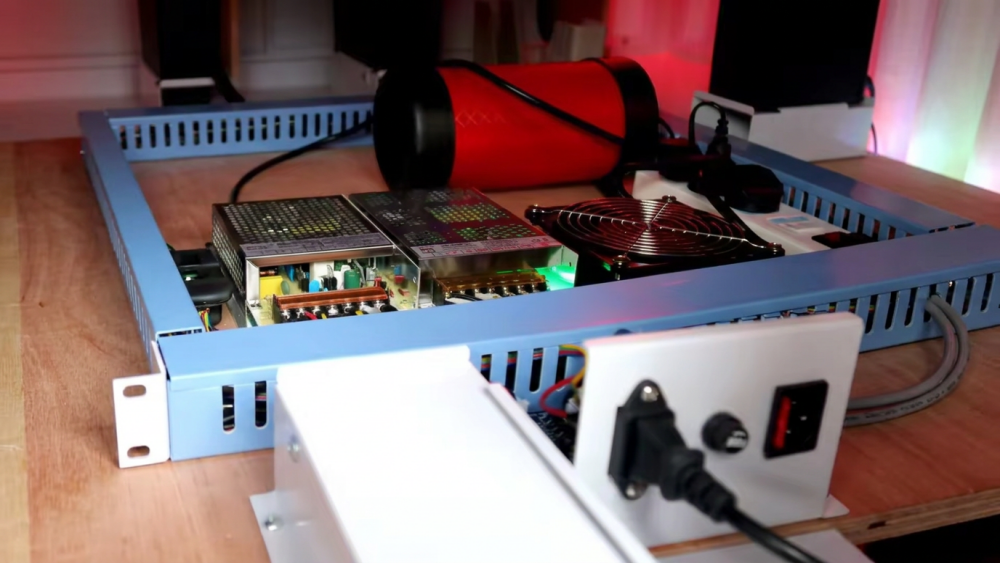 Technician checking power connections and service access behind arcade machines