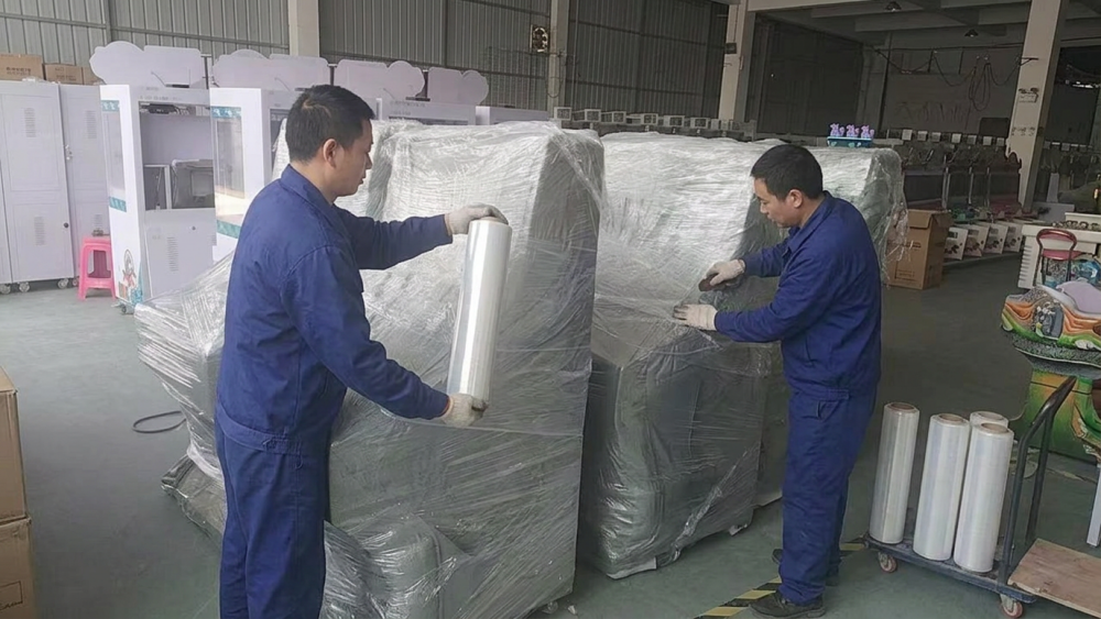Worker measuring the export packaging of a commercial arcade cabinet