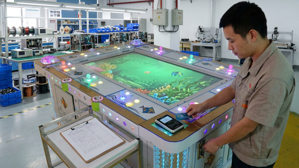 Technicians testing the payment system on a commercial fish game machine
