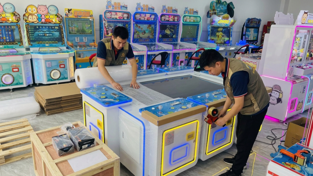 Technicians testing a multiplayer fish table game machine