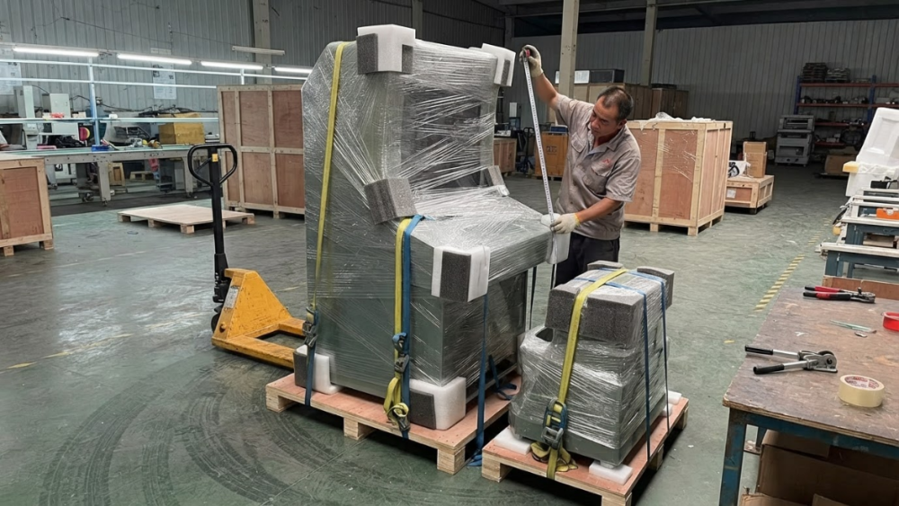 Export packed arcade cabinet being measured on a wooden pallet