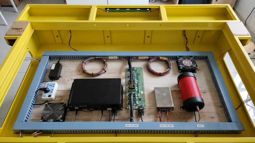 Technician checking PCB I/O board and wiring in an 8-player fish table