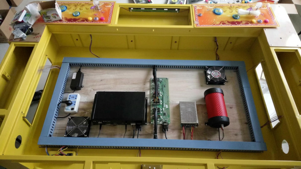 Payment-device wiring harness beside an I/O board inside a fish game cabinet
